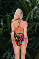 Model showing the high leg pants from behind. Black and rainbow print on luxury lycra from L•O•M