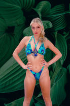 Front view of Model in power stance wearing bikini in Tribal Tales in turquoise and purple