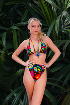 Lycra bikini top with high leg pants worn on model. Print is Femina Magicae