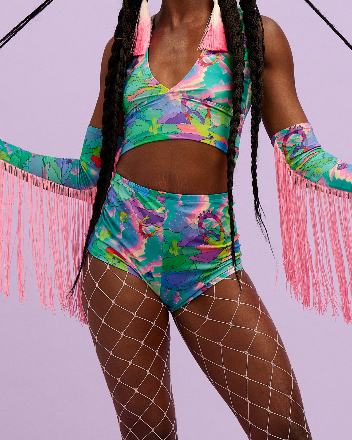 Model wearing Intergalactic Rodeo lycra Hot Pants with fishnet tights, top and fringed sleeves