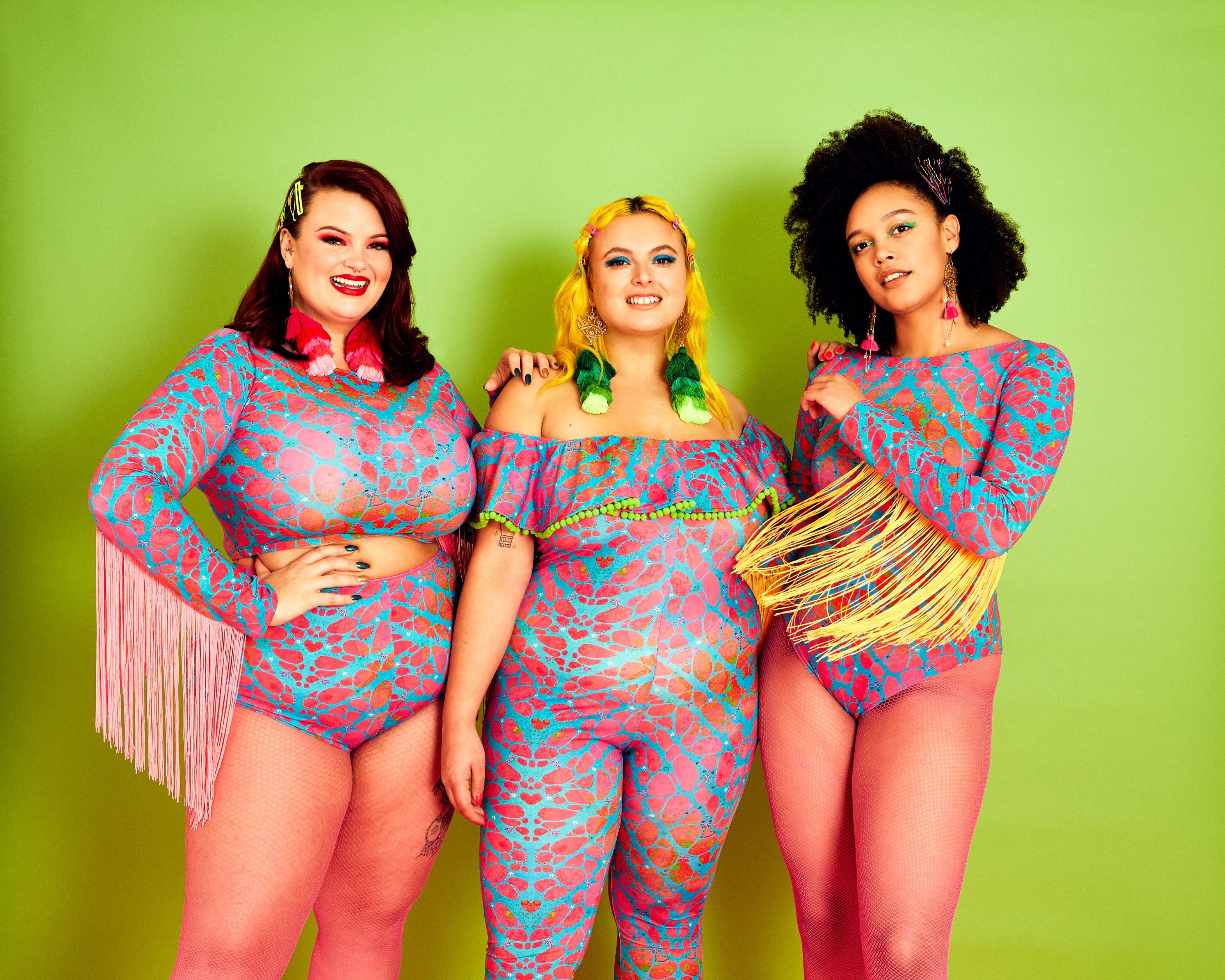 Three curvey ladies wearing lycra outfits in Pink and Light Blue print