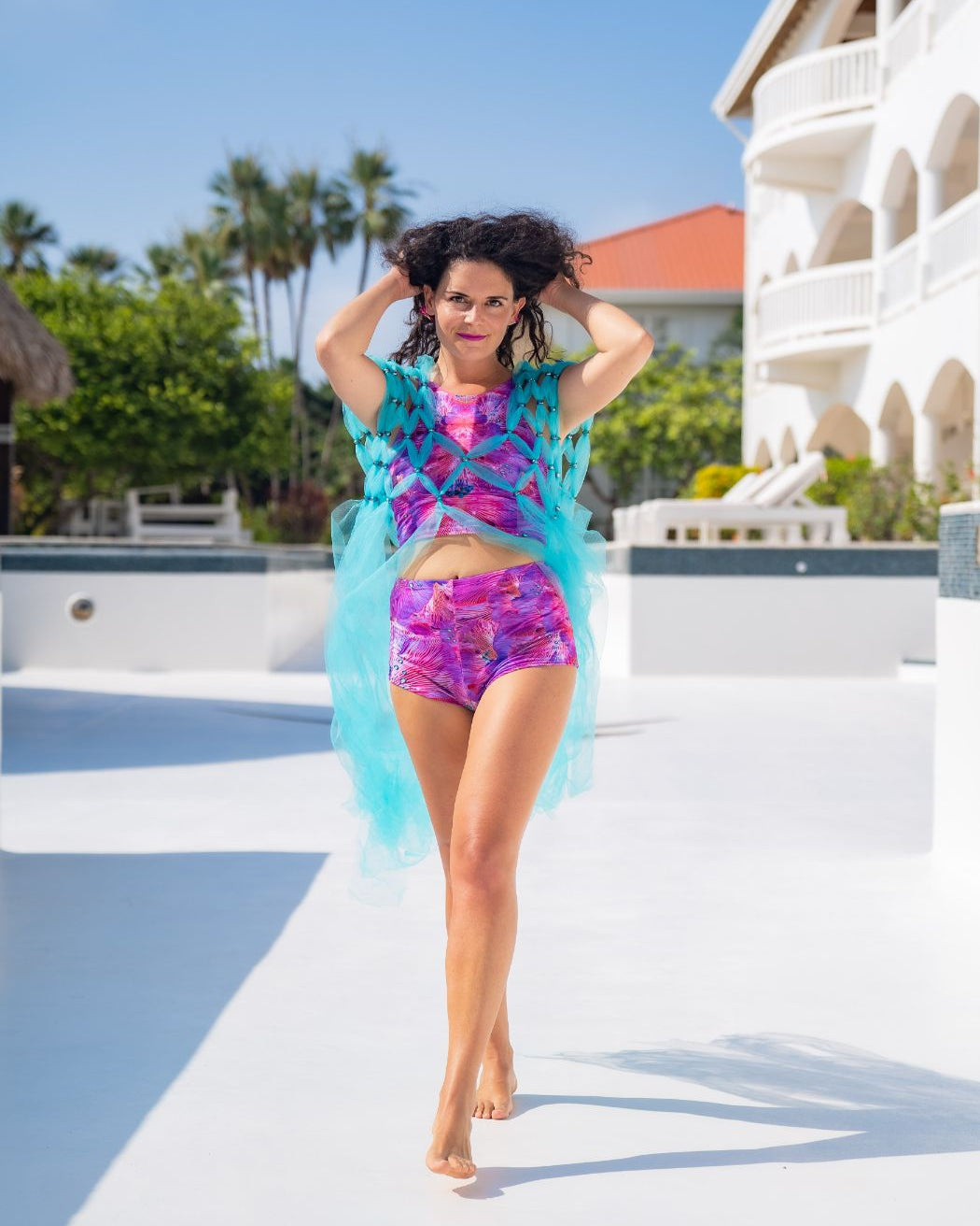 Model wearing matching two piece lycra hot pants and sleeveless crop top in pink forest of dreams print