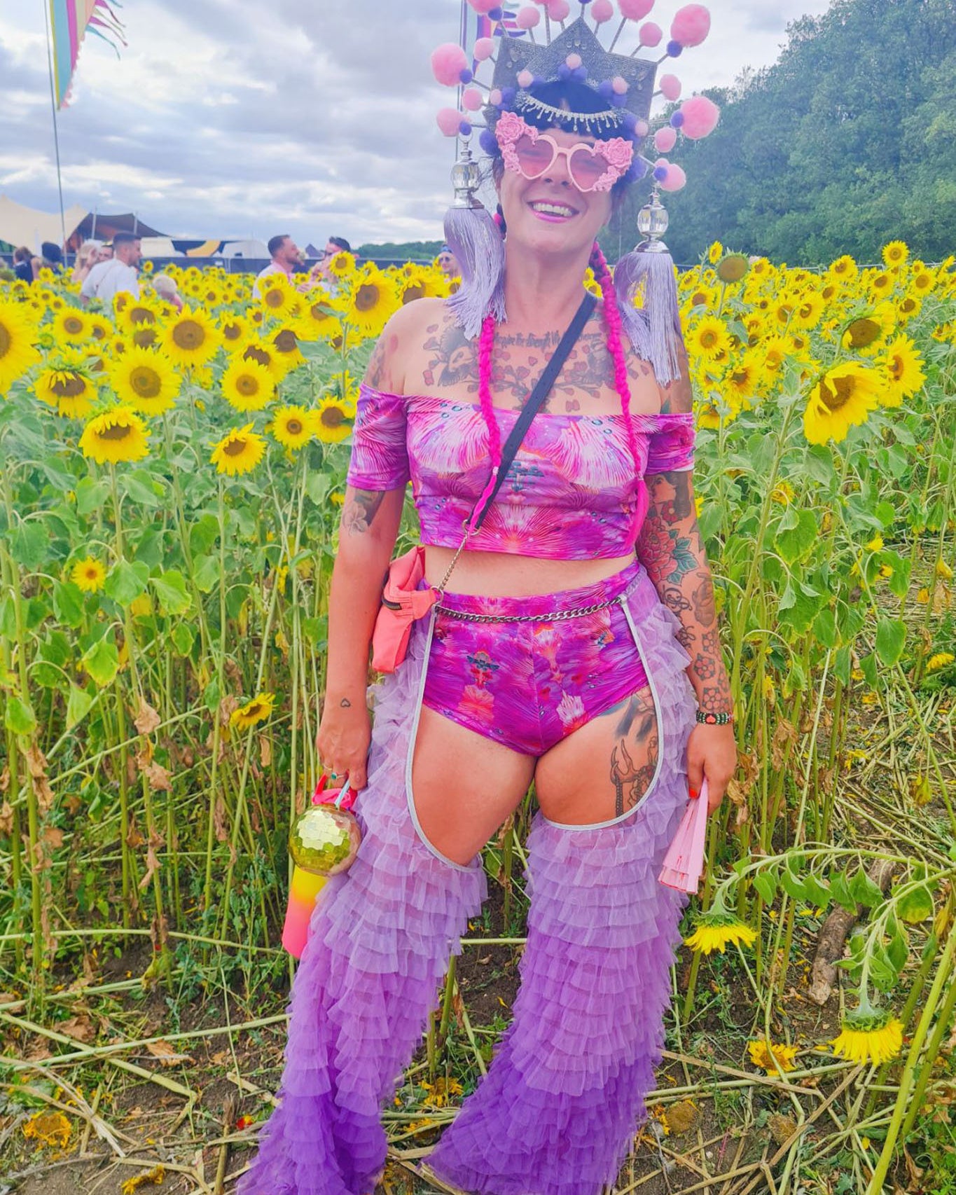 Model wearing matching forest opf dreams pink hot pants with off the shoulder lycra top