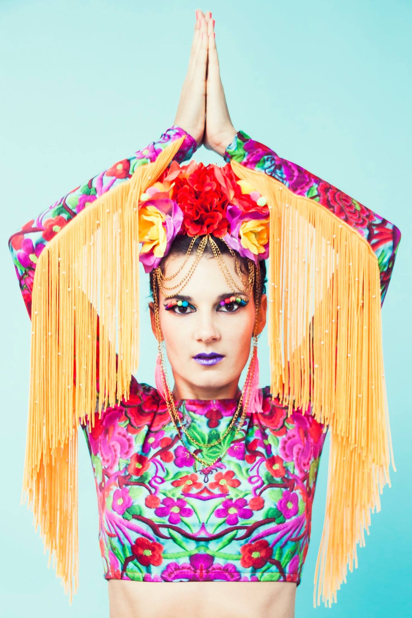 Model wearing lycra crop top with gold tassels