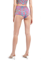 view of back of model wearing pink and blue hot pants