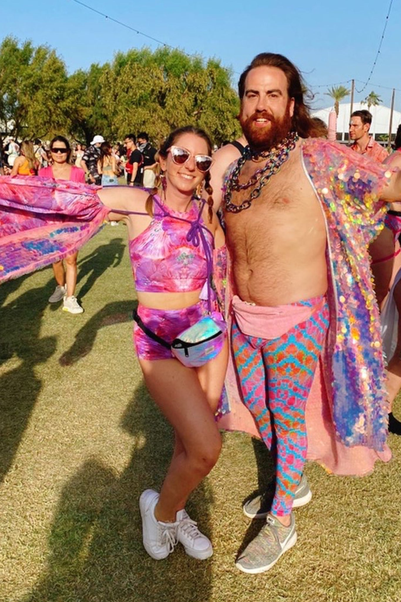 Festival goer wearing L•O•M pink forest of dreams print hot pants and sleeveless crop top