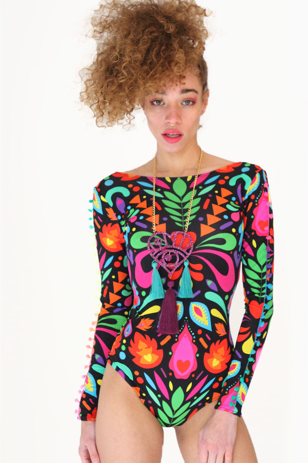 Model wearing long sleeve lycra bodysuit in femina magicae black rainbow print