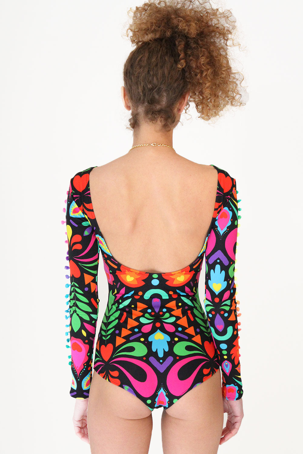 model showing the low back on black rainbow print lycra bodysuit